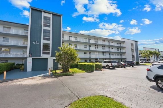 Front view of a multi-story apartment building with balconies.
