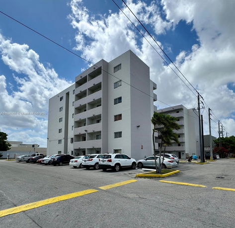 Front view of a multistory residential building with balconies.