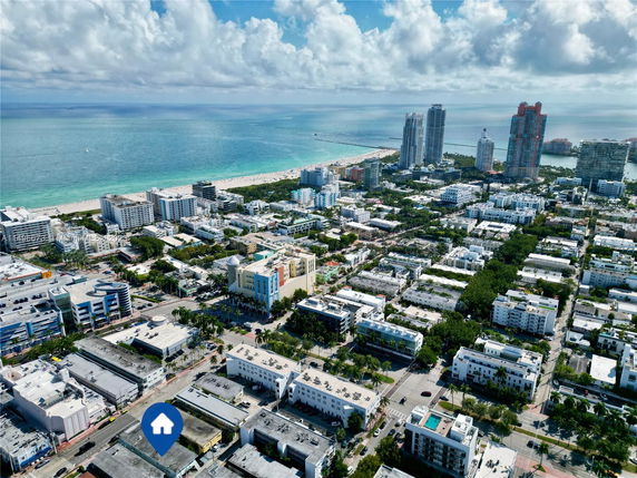 Aerial view of a coastal city with high-rise buildings and the ocean in the background.
