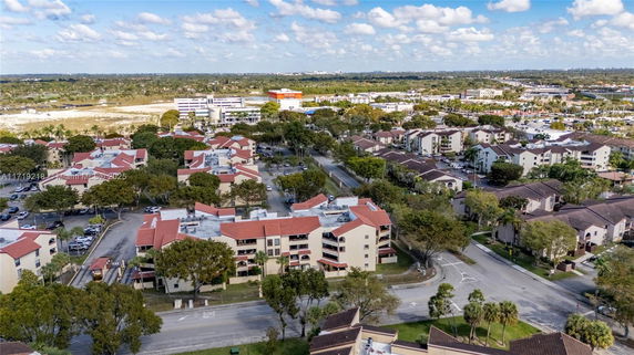 Aerial view of a residential neighborhood with multiple apartment buildings and parking areas.