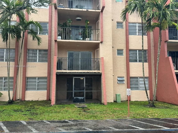 Front view of a multi-story apartment building with balconies.