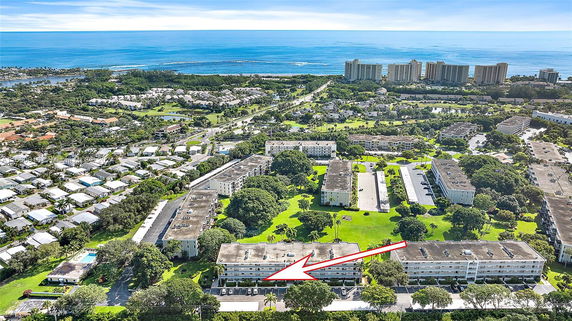 Aerial view of apartment buildings with a coastline in the background.
