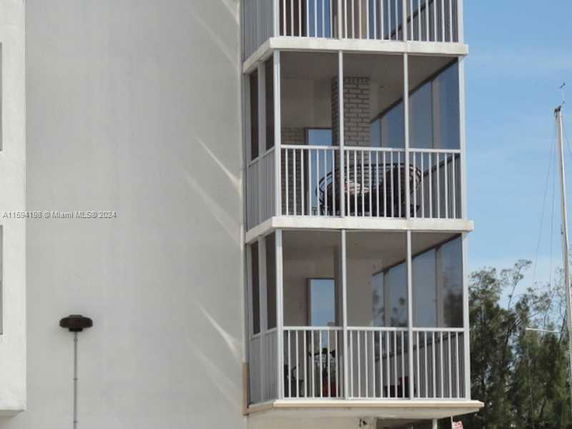 Front view of a multi-story building with balconies.