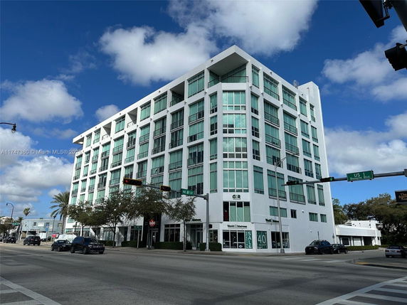 Front view of a multi-story commercial building on a street corner.