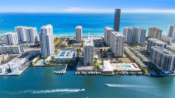 Panoramic view of a coastal cityscape with high-rise buildings near the ocean.