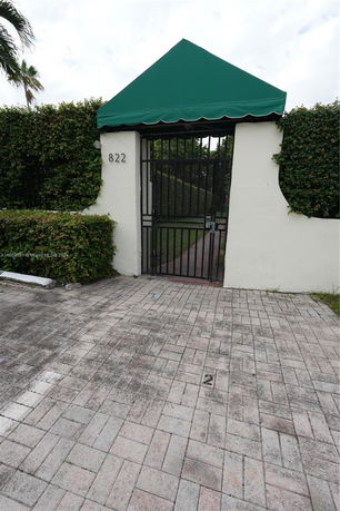 Entrance gate with green canopy.