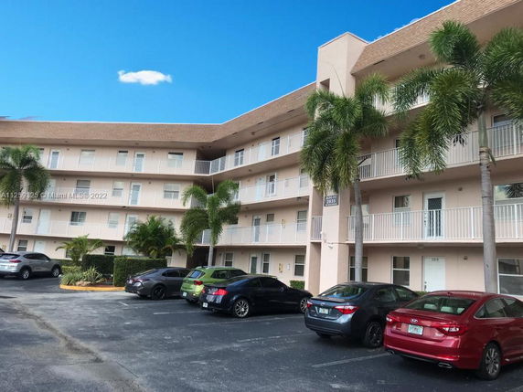 Front view of a multi-story residential building with balconies.