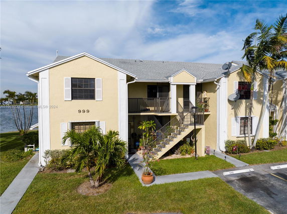 Front view of a two-story residential building with an external staircase.