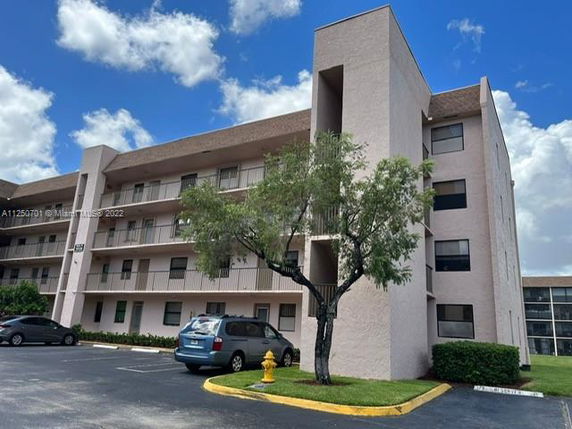 Front view of a multi-story residential building with balconies.