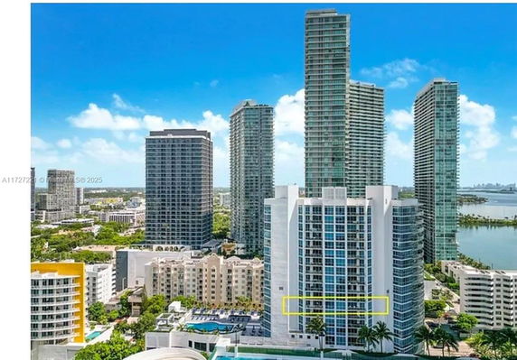 High-rise buildings with a view of a bay in the background.