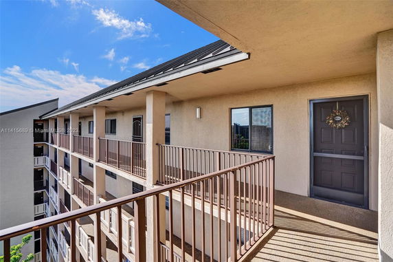 View of a rooftop with railing and doorway access.