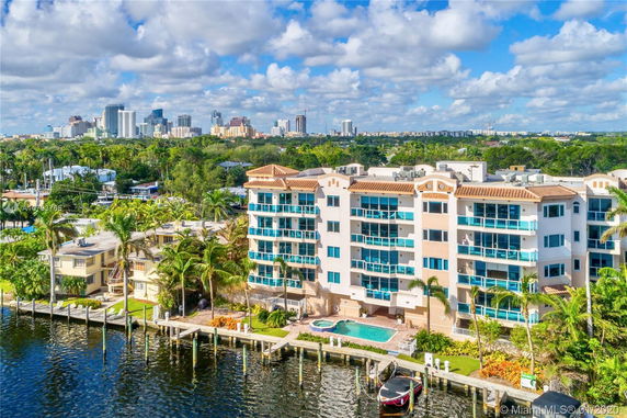 View of waterfront buildings and city skyline in the distance.