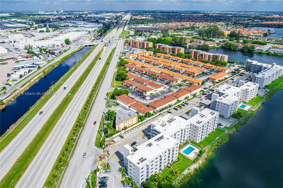 Aerial view of a residential area with rows of buildings and adjacent highways.