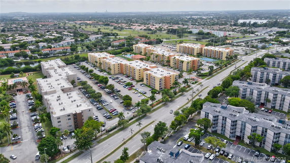Aerial view of a residential area with multiple apartment buildings and parking lots.