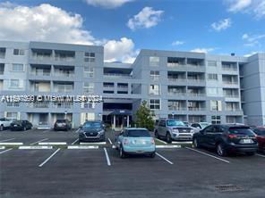Front view of a multi-story apartment building with balconies.
