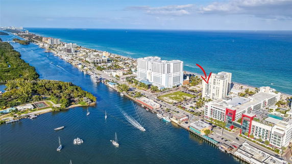 Wide-angle view capturing a coastal urban area with high-rise buildings near the ocean.