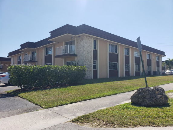 Front view of a two-story building with balconies.