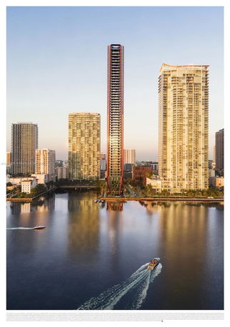 Front view of a tall high-rise building with surrounding skyscrapers near water.