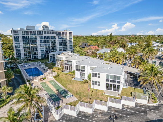 View of a modern apartment building with a swimming pool area.