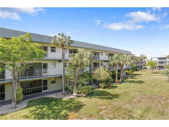 Front view of a multi-story residential building with balconies.