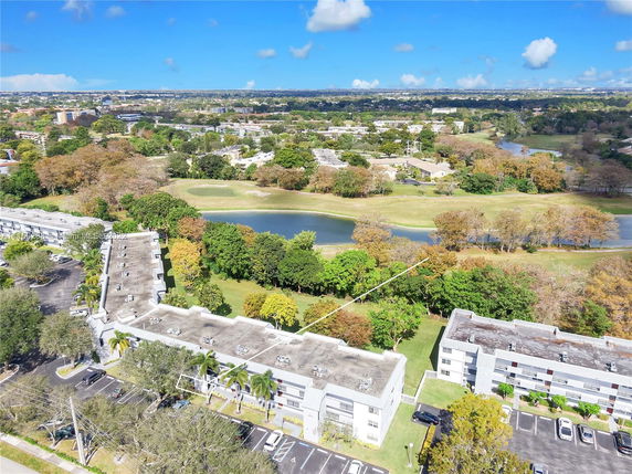 Panoramic view of a residential area with large buildings and a golf course.