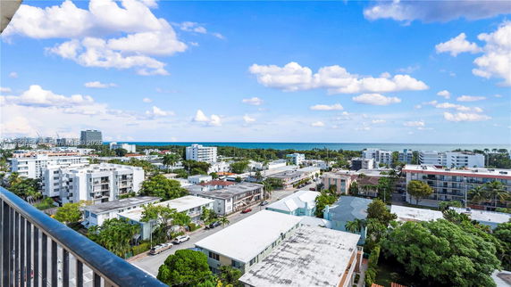 Wide view of buildings and ocean from a high vantage point.