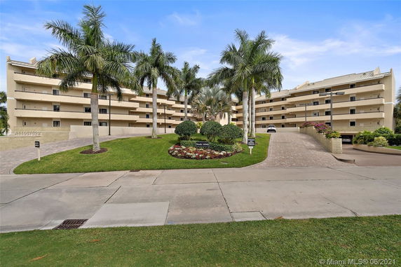 Front view of a multi-story residential building with balconies