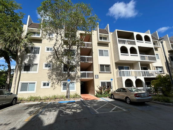 Front view of a multi-story residential building with balconies.