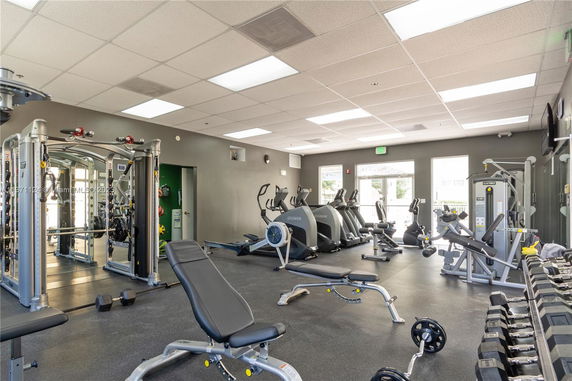 Indoor gym area with various exercise equipment and machines.