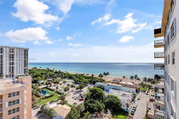 Panoramic view from a building overlooking the beach and ocean.