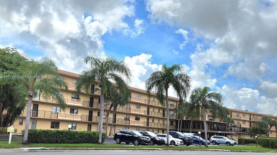 Front view of a multi-story apartment building with balconies.