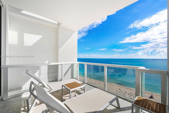 Panoramic view from a balcony overlooking the ocean.