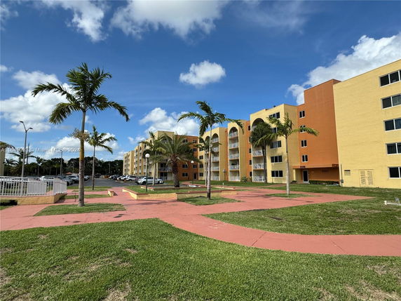 Front view of a multi-story residential building with balconies.