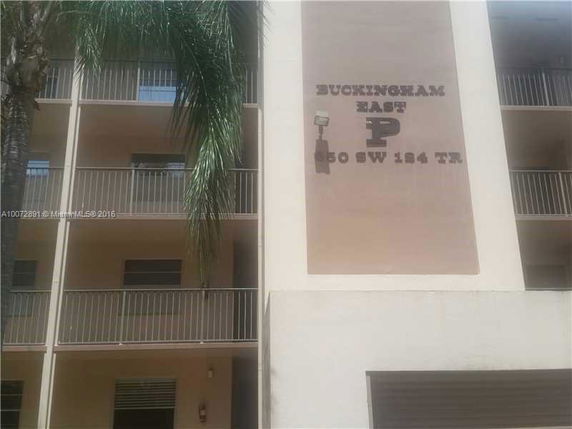 Front view of a multi-story residential building with balconies.