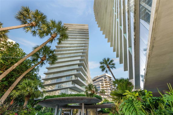 Front view of a modern multi-story building with extended balconies.