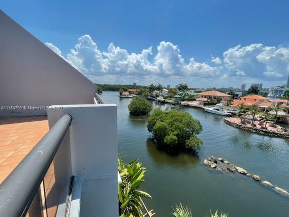 View from a building overlooking a river and surrounding areas with residential properties and greenery.