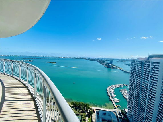 Panoramic view from a high-rise building overlooking the ocean and cityscape.