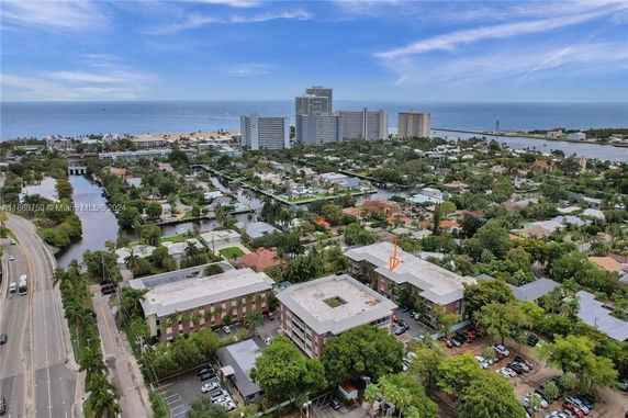 Wide angle view of residential area with several buildings and the ocean in the background.