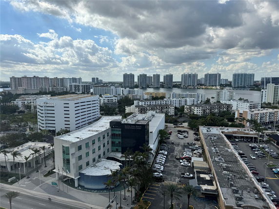 View of multiple high-rise buildings near a water body, as seen from above.