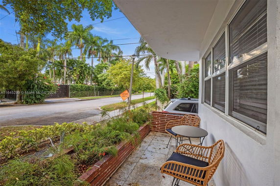 Outdoor view of a roadway with tropical trees and residential street.