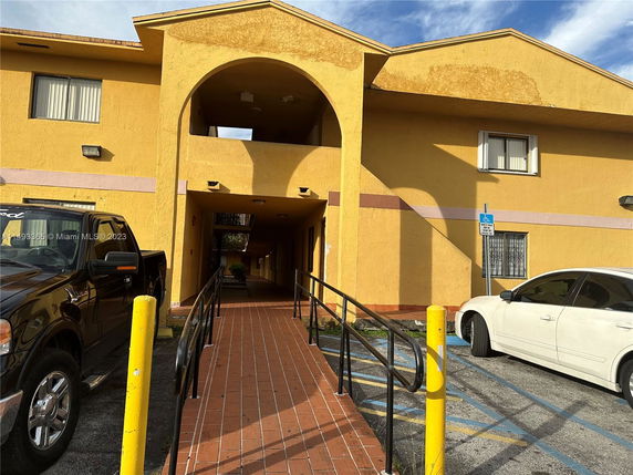 Front view of a two-story building with archway entrance.