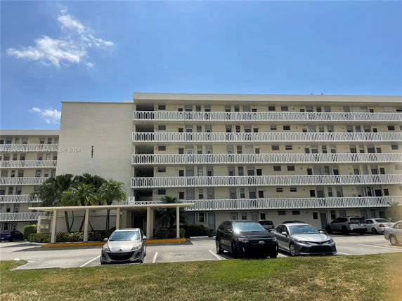Front view of a multi-story residential building with balconies.