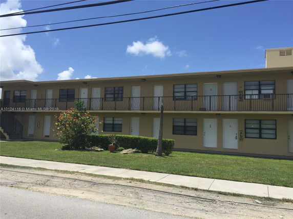 Front view of a two-story apartment building with multiple entrances.