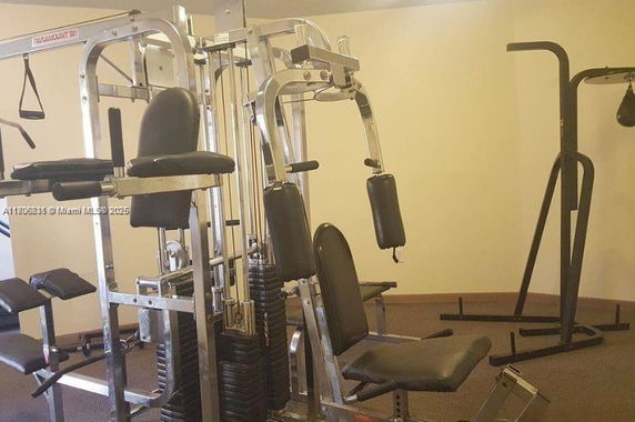 Indoor gym area with exercise equipment.