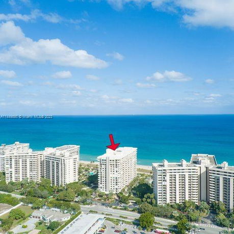 Aerial view of multiple high-rise buildings near a coastline.