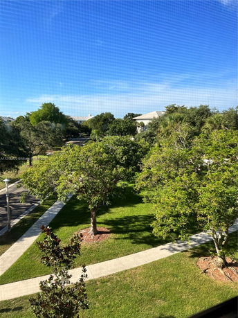 View of surrounding area with trees and pathways visible.