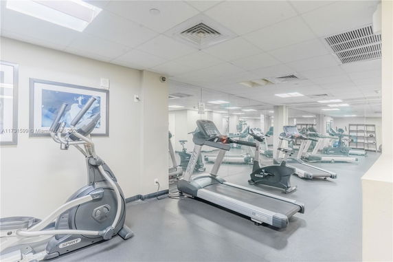 Interior view of a gym with exercise equipment including treadmills and elliptical machines.