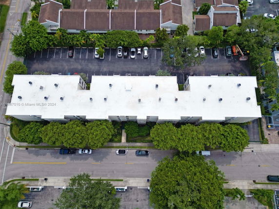 Aerial view of a building rooftop with features such as vents or antennas.