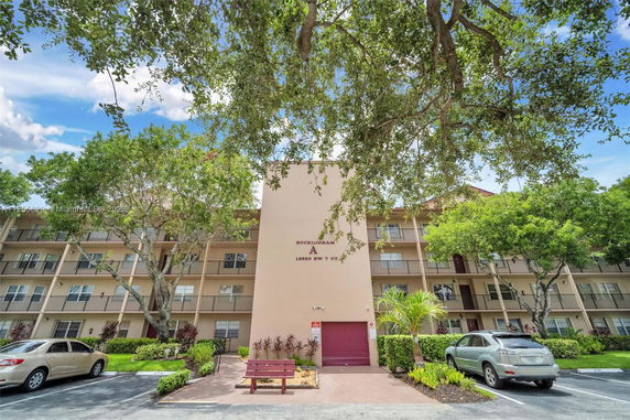 Front view of a multi-story residential building with balconies.