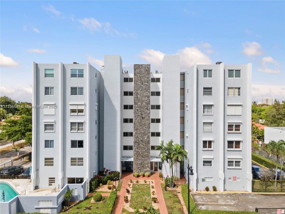 Front view of a multi-story residential building with a central stone facade.